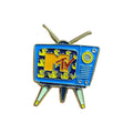 Retro MTV enamel pin designed as a vintage blue television with antennas, featuring the classic MTV logo and colorful 90s-style screen pattern
