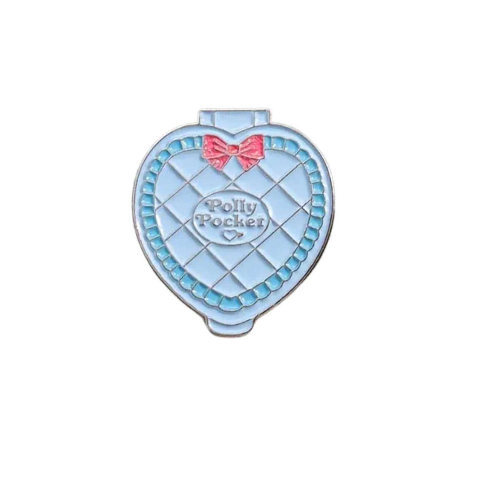 Heart shaped enamel pin inspired by Polly Pocket compact toy with pastel blue design and pink bow