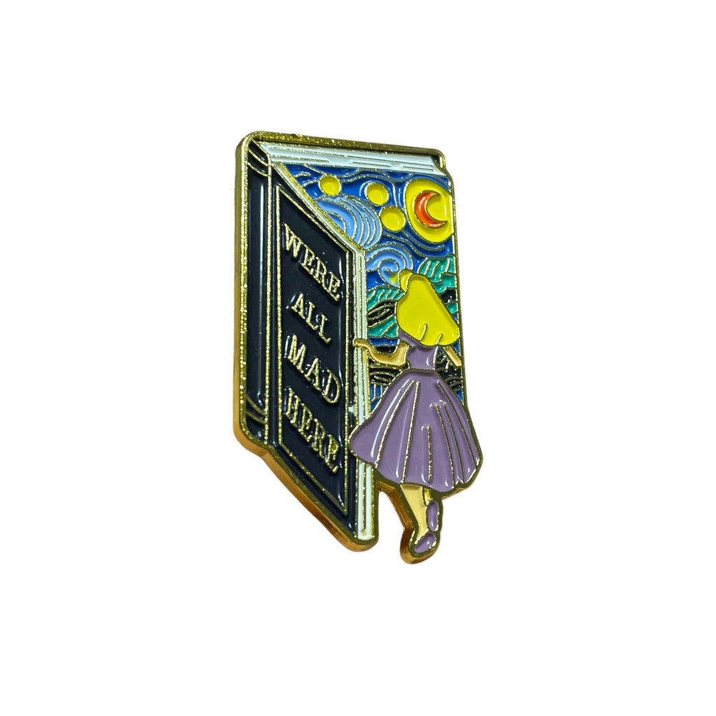 We’re All Mad Here enamel pin with open book and whimsical night sky Alice in Wonderland inspired design