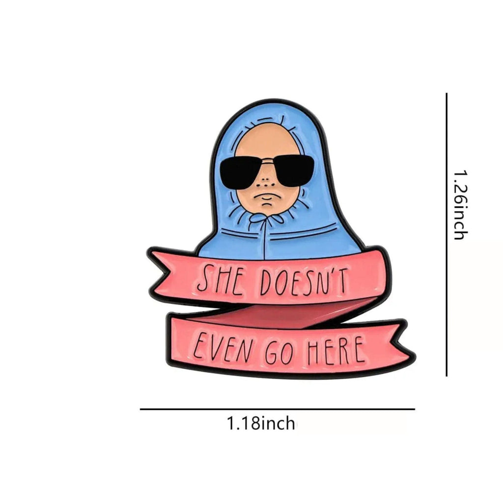 Funny enamel pin featuring a cartoon character in sunglasses with a banner reading “She Doesn’t Even Go Here” inspired by Mean Girls quote